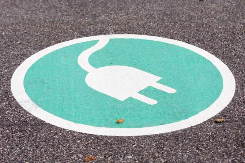 Painted road sign indicating electric car charging station seen in Lindholmen Science Park in Gothenburg