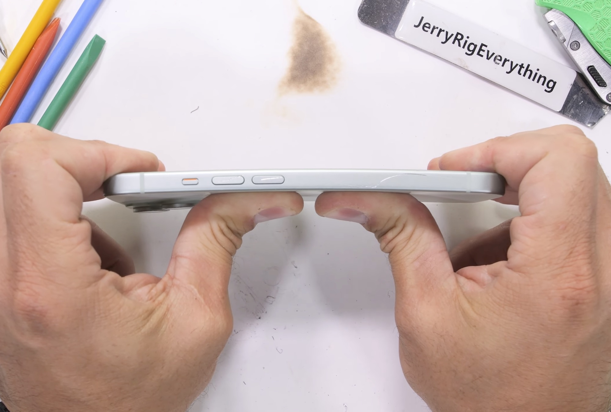 YouTuber Zack Nelson bending an iPhone 15 to test its strength.