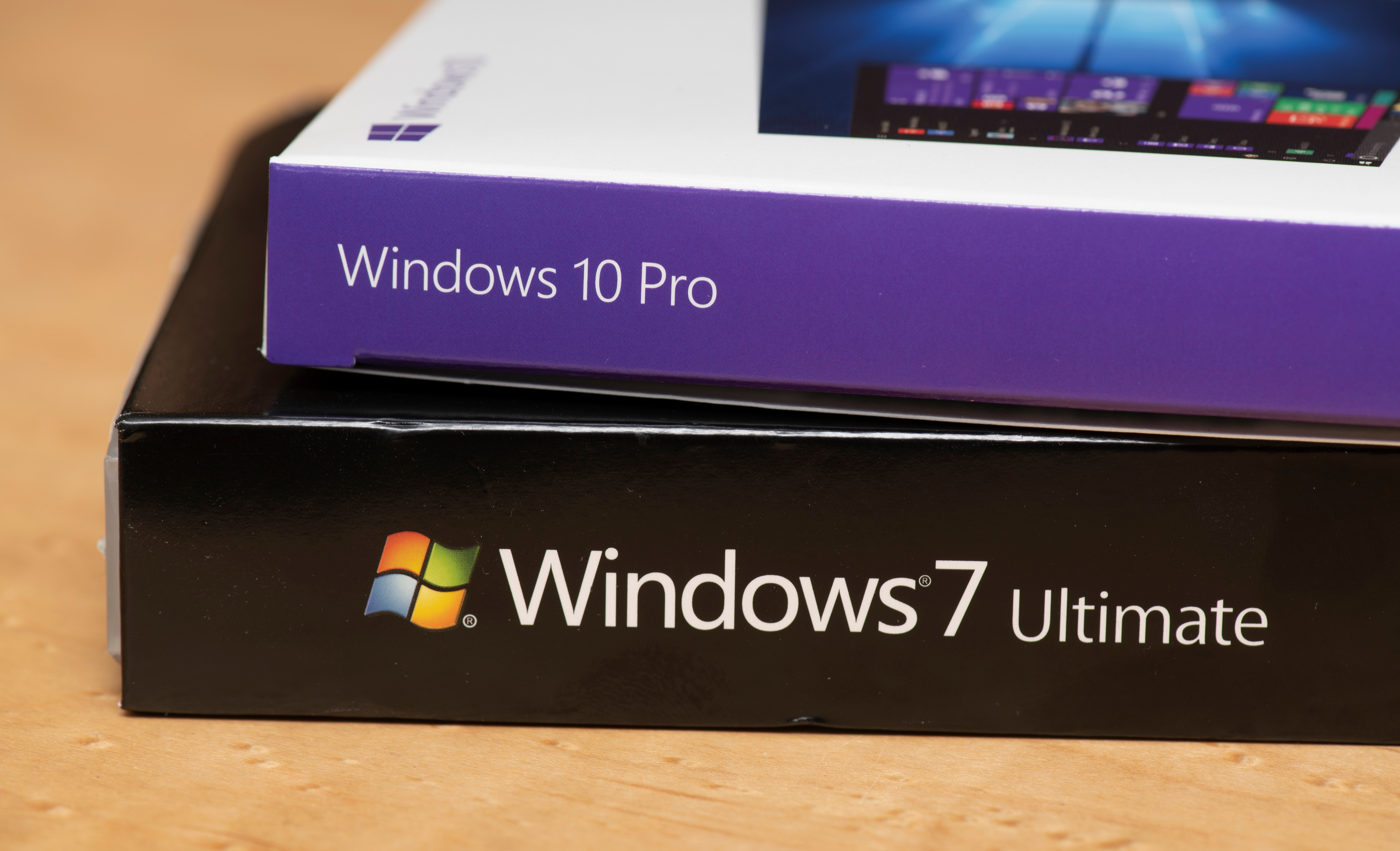 Windows 10 Pro box stacked on top of a Windows 7 ultimate box