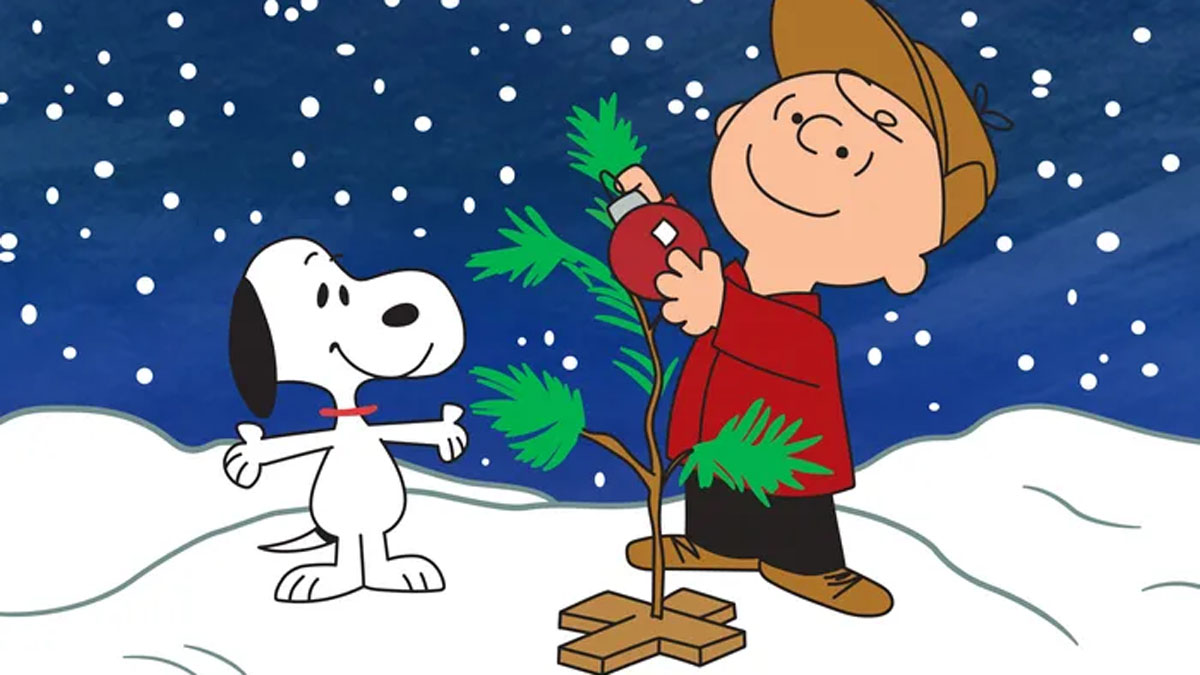 Snoopy and Charlie Brown decorate a Christmas tree in A Charlie Brown Christmas.